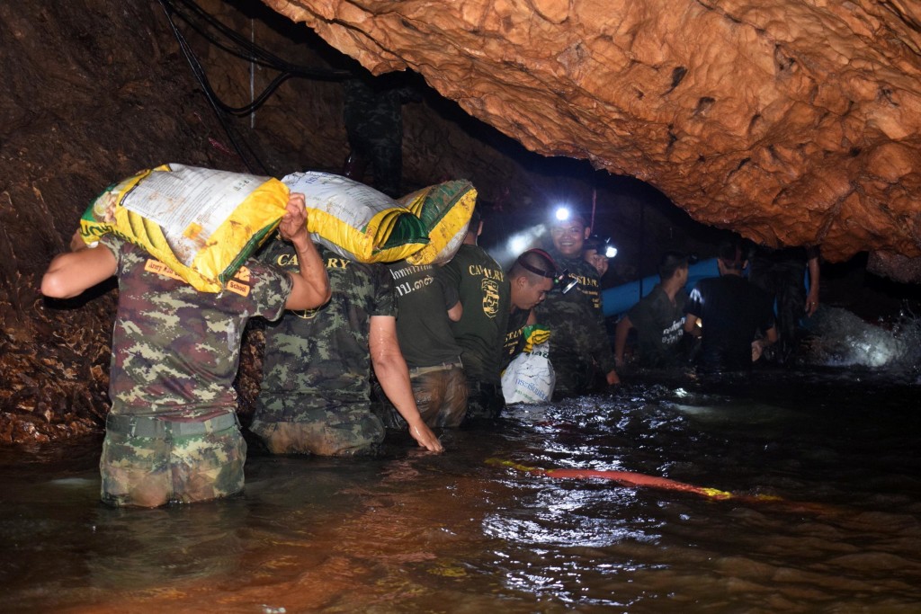 epa06858273 An undated handout photo released by Royal Thai Army on 02 July 2018 shows Thai soldiers carrying equipments inside the flooded cave complex during a rescue operation for a missing youth soccer team and their coach at Tham Luang cave in Khun Nam Nang Non Forest Park, Chiang Rai province, Thailand. Rescuers are attempting to pump water out of a cave complex in an effort to continue the rescue of 13 young members of a youth soccer team including their coach that are believed to have been trapped in the flooded cave complex since 23 June 2018. EPA/ROYAL THAI ARMY HANDOUT EDITORIAL USE ONLY/ NO SALES HANDOUT EDITORIAL USE ONLY/NO SALES